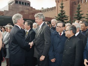 In this Tuesday, May 9, 1995 file image, Dutch Prime Minister Wim Kok, center, shakes hands with U.S. President Bill Clinton in Moscow's Red Square just before the Victory parade. Current Dutch prime minister Mark Rutte said that former premier Wim Kok, a trade unionist-turned-politician who inspired a new breed of pragmatic Social Democratic leaders in Europe, has died at age 80.
