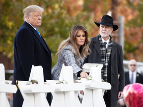 U.S. President Donald Trump and First Lady Melania Trump, alongside Rabbi Jeffrey Myers, place stones and flowers on a memorial as they pay their respects at the Tree of Life Synagogue following last weekend's shooting in Pittsburgh, Pennsylvania, Oct. 30, 2018.