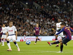 Barcelona forward Philippe Coutinho scores his sides first goal during the Champions League Group B soccer match between Tottenham Hotspur and Barcelona at Wembley Stadium in London,, Wednesday, Oct. 3, 2018.