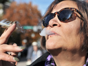 A woman smokes marijuana in Vancouver on Oct. 17, 2018 — the first day it was legalized.