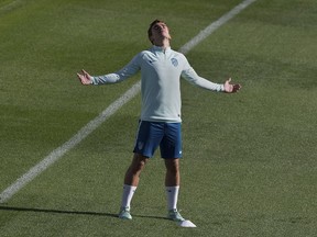 Atletico Madrid's Antoine Griezmann stretches in the sun during a training session in Madrid, Spain, Tuesday Oct. 2, 2018. Atletico will play Club Brugge on Wednesday in a Group A Champions League soccer match.