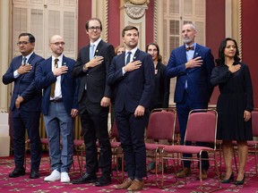 Quebec Solidaire MNAs pledge allegiance to Quebec after they were sworn in as members of the National Assembly on Oct. 17, 2018, at the legislature in Quebec City. They chose to pledge allegiance to the Queen in private. From the left, first row, Andres Fontecilla, Sol Zanetti, Alexandre Leduc and Gabriel Nadeau Dubois, second row, Christine Labrie, Emilie Lessard-Therrien, Vincent Marissal and Ruba Ghazal.