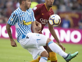 Spal's Alberto Paloschi, left, vies for the ball with Steven Nzonzi of Roma during the Italian Serie A soccer match between Roma and Spal, at Olimpico stadium in Rome, Italy, Saturday, Oct. 20, 2018.