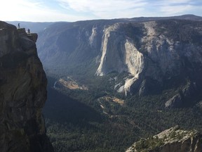 FILE - In this Thursday, Sept. 27, 2018 file photo, an unidentified couple gets married at Taft Point in California's Yosemite National Park. The viewpoint overlooks Yosemite Valley, including El Capitan, a popular vertical ascent for rock climbers across the globe. Yosemite National Park officials have identified two people who died after falling from a popular overlook as a man and a woman from India who were living and working in the United States. Park officials said Monday, Oct. 29, 2018 they were 29-year-old Vishnu Viswanath and his 30-year-old female companion, Meenakshi Moorthy. Park officials recovered their bodies about 800 feet (245 meters) below Taft Point last week.
