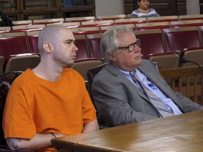 FILE - In this Sept. 27, 2017, file photo, prison inmate Casey Pigge, left, waits before he enters his guilty plea to strangling a fellow prisoner in a transport van earlier this year, at a hearing attended by his lawyer, Steve Larson in Circleville, Ohio. Prosecutors have charged two prison inmates, Pigge and Greg Reinke, in separate knife attacks at an Ohio prison that left a guard severely wounded and injured four prisoners unable to defend themselves because they were handcuffed to a table.