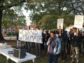 Maya Little uses a microphone to address several dozen supporters before her trial Monday, Oct. 15, 2018, in Hillsborough, N.C., on a charge that she poured red ink on a Confederate statue at the University of North Carolina that was later torn down by protesters. Little has been charged with a count of misdemeanor defacing of a public monument for her action last April at the statue known as "Silent Sam," which was torn down by protesters in August.