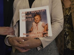Carolyn Fortney, a survivor of sexual abuse at the hands of her family's Roman Catholic parish priest as a child, awaits legislation in the Pennsylvania Capitol to respond to a landmark state grand jury report on child sexual abuse in the Catholic Church, Wednesday, Oct. 17, 2018 in Harrisburg, Pa.
