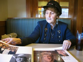 In this Wednesday, Oct. 3, 2018 photo, Lewis and Clark Republican Women President Shirley Herrin looks at photographs of former Montana Gov. Judy Martz in Helena, Mont. Herrin and Democratic party leaders say women are highly motivated to vote in this year's election.