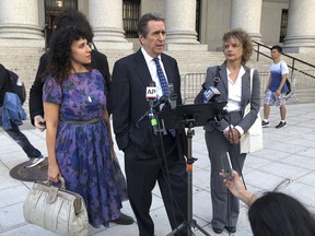 From left, Kristine Rakowsky, civil rights lawyer Norman Siegel,and Liane Nikitovich, meet with reporters outside federal court in New York on Wednesday, Oct. 3, 2018. The women filed a lawsuit arguing they should not be compelled to receive emergency alerts from the government on their phones.