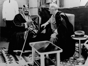 FILE - In this Feb. 14, 1945 file photo, U.S. President Franklin D. Roosevelt, right, and King Abdul Aziz Ibn Saud discuss Saudi-U.S. relations aboard USS Quincy in the Great Bitter Lake north of the city of Suez, Egypt. The kingdom of Saudi Arabia has enjoyed the ultimate protected status from the U.S. throughout its short history, from  Roosevelt meeting Saudi Arabia's first king on Valentine's Day in 1945 to the kingdom becoming America's main Mideast ally following the downfall of Iran's shah in 1979. (AP Photo, File)