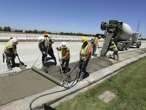 FILE In this July 11, 2018 file photo, workers repave a street in Roseville, Calif., partially funded by a gas tax hike passed by the Legislature in 2017. Leaders of the Proposition 6 campaign to repeal California's recent gas tax increase are asking the federal government to investigate their claims that public resources have been used against them. A spokeswoman for the anti-Proposition 6 campaign countered the allegations, saying the campaign follows all laws.