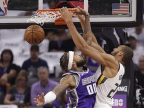 Utah Jazz center Rudy Gobert, right, scores over Sacramento Kings center Willie Cauley-Stein during the first quarter of an NBA basketball game Wednesday, Oct. 17, 2018, in Sacramento, Calif.