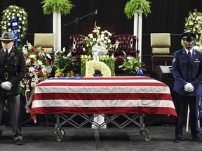 CORRECTS LAST NAME TO CARRAWAY FROM CARAWAY - A color guard stands at attention before a funeral service for fallen Florence police officer Sgt. Terrence Carraway on Monday, Oct. 8, 2018, at the Florence Center in Florence, S.C. Sgt. Carraway was killed in the line of duty Wednesday, Oct. 3, 2018.