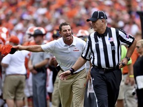 Clemson head coach Dabo Swinney reacts and discusses a call with an official during the first half of an NCAA college football game against Syracuse, Saturday, Sept. 29, 2018, in Clemson, S.C.