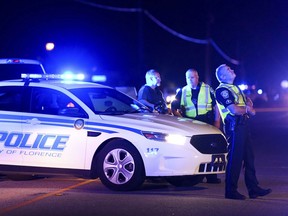 Authorities direct traffic on Hoffmeyer Road near the Vintage Place neighborhood where several law enforcement officers were shot, one fatally, Wednesday, Oct. 3, 2018, in Florence, S.C.
