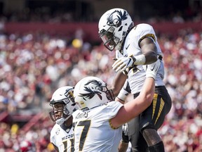 Missouri running back Larry Rountree III, right, celebrates a touchdown with Paul Adams (77) during the first half of an NCAA college football game against South Carolina Saturday, Oct. 6, 2018, in Columbia, S.C.