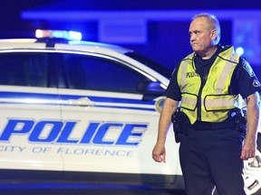 A police officer directs traffic on Hoffmeyer Road near the Vintage Place neighborhood where three deputies and two city officers were shot Wednesday, Oct. 3, 2018, in Florence, S.C.