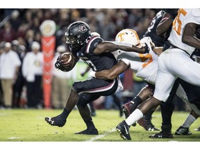 South Carolina running back Ty'Son Williams (27) is wrapped up by Tennessee defensive lineman Kyle Phillips (5) during the first half of an NCAA college football game Saturday, Oct. 27, 2018, in Columbia, S.C.
