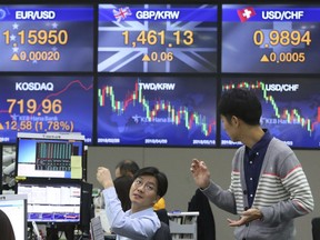 Currency traders work at the foreign exchange dealing room of the KEB Hana Bank headquarters in Seoul, South Korea, Friday, Oct. 12, 2018. Asian stocks were mixed on Friday as better-than-expected Chinese trade data gave some markets a breather from worries about the impact of punitive tariffs.