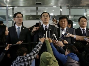 South Korean Unification Minister Cho Myoung-gyon, center, speaks to the media before leaving for the border village of Panmunjom to attend a meeting between South and North Korea, at the Office of the South Korea-North Korea Dialogue in Seoul, South Korea, Monday, Oct. 15, 2018.