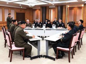 FILE - In this Oct. 16, 2018, file photo provided by South Korea Defense Ministry, the U.S.-led United Nations Command, center, South Korean and North Korean, left, military officers attend a meeting at the southern side of Panmunjom in the Demilitarized Zone, South Korea. The two Koreas and the U.S.-led U.N. Command on Monday, Oct. 22, 2018, are meeting again at the Koreas' border village to examine an ongoing effort to disarm the area. (South Korea Defense Ministry via AP, File)