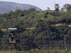 In this on Sunday, Sept. 30, 2018 photo, military guard posts of North Korea, right top, and South Korea, left bottom, are seen in Paju, at the border with North Korea, South Korea. Seoul on Monday, Oct. 1, 2018, says South Korea has begun clearing mines from two sites inside the heavily fortified border with North Korea under a package of tension-reduction deal between the rivals.