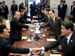 South Korean Unification Minister Cho Myoung-gyon, center right, shakes hands with his North Korean counterpart Ri Son Gwon during their meeting at the southern side of Panmunjom in the Demilitarized Zone, South Korea, Monday, Oct. 15, 2018. The rival Koreas are holding high-level talks Monday to discuss further engagement amid a global diplomatic push to resolve the nuclear standoff with North Korea. (Korea Pool/Yonhap via AP)