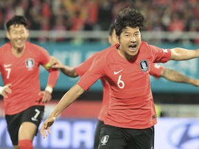 South Korea's Hwang Hee-chan, right, celebrates after scoring the first goal against Panama during a friendly soccer match in Cheonan, South Korea, Tuesday, Oct. 16, 2018.