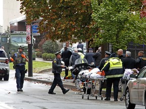 First responders surround the Tree of Life Synagogue, rear center, in Pittsburgh, where a shooter opened fire Saturday, Oct. 27, 2018, wounding three police officers and causing "multiple casualties" according to Police.
