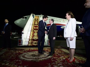 Prime Minister Justin Trudeau talks with Armenian Foreign Minister Zohrab Mnatsakanyan as he is greeted upon his arrival in Yerevan, Armenia on Wednesday, Oct. 10, 2018, to attend la Francophonie summit.