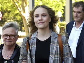 Actress Eryn Jean Norvill, center, leaves the Federal Court in Sydney, Australia, Tuesday, Oct. 30, 2018, after giving evidence during a defamation trial brought on by fellow actor Geoffrey Rush. Rush is suing the publisher of Sydney's The Daily Telegraph newspaper for defamation over articles that accused the 67-year-old Australian actor of behaving inappropriately toward Norvill during the Sydney Theatre Company's production of "King Lear" in 2015 and 2016.