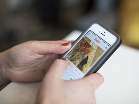 A person using the Tinder app on a phone