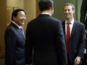 FILE - In this Sept. 23, 2015, file photo, Chinese President Xi Jinping, center, talks with Facebook Chief Executive Mark Zuckerberg, right, as Lu Wei, left, China's Internet czar, looks on during a gathering of CEOs and other executives at Microsoft's main campus in Redmond, Wash. Lu was standing trial Friday, Oct. 19, 2018 on corruption allegations, state media reported.