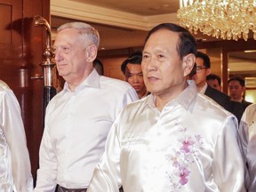 FILE - In this Oct. 19, 2018, file photo, U.S. Defense Secretary Jim Mattis, left, and Chinese Defense Minister Wei Fenghe attend a gala dinner at the 12th ASEAN Defense Ministers' Meeting in Singapore. U.S. officials say they sense that relations with the Chinese military, after a rocky few months, may be stabilizing, although face-to-face talks between their respective defense chiefs produced no new agreements.