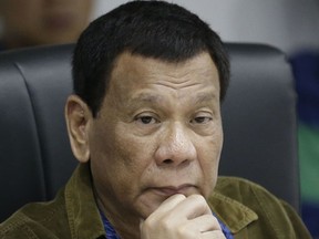 In this Sept. 13, 2018, file photo, Philippine President Rodrigo Duterte listens during a command conference on Typhoon Mangkhut, locally named Typhoon Ompong, at the National Disaster Risk Reduction and Management Council operations center in metropolitan Manila, Philippines. President Duterte said Thursday, Oct. 4, he might have cancer and added that "I don't know where I'm now physically" as he awaited the result of recent medical tests.