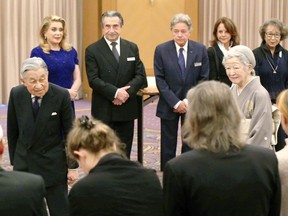 Japan's Emperor Akihito, left, and Empress Michiko greet Praemium Imperiale culture award winners including French actress Catherine Deneuve, rear left, in its reception in Tokyo, Tuesday, Oct. 23, 2018.