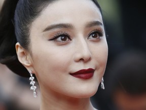FILE - In this May 24, 2017, file photo, Fan Bingbing poses for photographers as she arrives for the screening of the film The Beguiled at the 70th international film festival, Cannes, southern France. Chinese media said on Wednesday, Oct. 3, 2018, tax authorities ordered X-Men star Fan to pay taxes and fines worth hundreds of millions of yuan but would spare her from criminal prosecution.