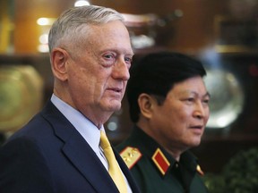 U.S. Secretary of Defense Jim Mattis, left, and Vietnam's Defense Minister Gen. Ngo Xuan Lich leave a meeting room in Ho Chi Minh City, Vietnam, Wednesday, Oct. 17, 2018.