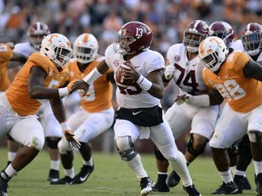 Tennessee defensive lineman Kyle Phillips (5) and Tennessee defensive lineman Alexis Johnson Jr. (98) go after Alabama quarterback Tua Tagovailoa (13) during the first half of an NCAA college football game, Saturday, Oct. 20, 2018, in Knoxville, Tenn.