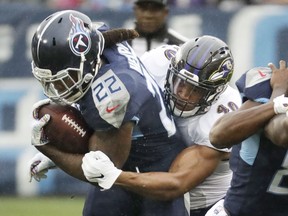 Tennessee Titans running back Derrick Henry (22) is stopped by Baltimore Ravens linebacker Kenny Young (40) in the first half of an NFL football game Sunday, Oct. 14, 2018, in Nashville, Tenn.