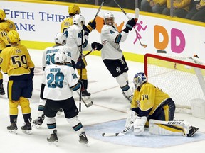 San Jose Sharks players celebrate after center Tomas Hertl (48), of the Czech Republic, scored a goal against Nashville Predators goaltender Juuse Saros (74), of Finland, in the second period of an NHL hockey game, Tuesday, Oct. 23, 2018, in Nashville, Tenn.