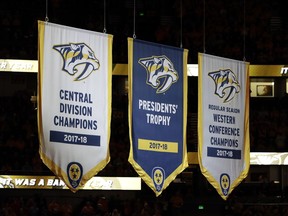 The Nashville Predators' banners as winners of the Presidents' Trophy, Central Division and Western Conference are raised before an NHL hockey game against the Calgary Flames Tuesday, Oct. 9, 2018, in Nashville, Tenn.