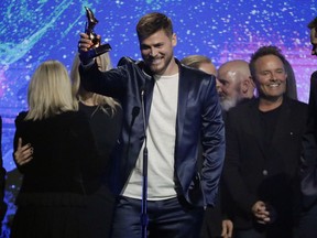 Cory Asbury accepts the song of the year award for "Reckless Love" during the Dove Awards on Tuesday, Oct. 16, 2018, in Nashville, Tenn.