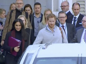 In this image made from video, Britain's Prince Harry, center right, and his wife Meghan Markle, left, Duke and Duchess of Sussex, approach a car at an airport in Sydney, Monday, Oct. 15, 2018. Prince Harry and his wife Meghan arrived in Sydney on Monday, a day before they officially start a 16-day tour of Australia and the South Pacific.(Australian Pool via AP)