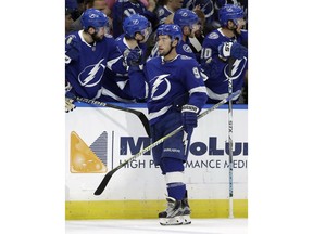 Tampa Bay Lightning center Tyler Johnson (9) celebrates with the bench after scoring against the Carolina Hurricanes during the first period of an NHL hockey game Tuesday, Oct. 16, 2018, in Tampa, Fla.