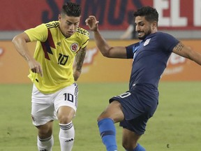 Colombia's James Rodriguez (10) moves the ball past Unites States' Kenny Saief during the first half of an international friendly soccer match Thursday, Oct. 11, 2018, in Tampa, Fla.