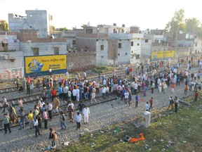 Indian people gather at the scene of an accident along railroad tracks in Amritsar on October 20, 2018, after revellers who gathered on the tracks were killed by a moving train on October 19. - A speeding train ran over revellers watching fireworks during a Hindu festival in northern India on October 19, killing more than 50 people, with eyewitnesses saying they were given no warning before disaster struck.