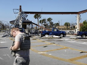 A soldier stands guard at the damaged entrance to Tyndall Air Force Base in Panama City, Fla., Thursday, Oct. 11, 2018, in the aftermath of Hurricane Michael.