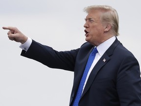 President Donald Trump gestures as he steps off Air Force One after arriving at Philadelphia International Airport, Tuesday, Oct. 2, 2018, in Philadelphia.