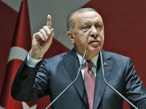 Turkey's President Recep Tayyip Erdogan talks to members of his ruling Justice and Development Party in Ankara, Turkey, Friday, Oct. 26, 2018.